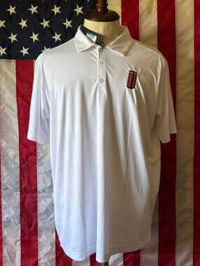 White performance polo shirt featuring an embroidered red British telephone box